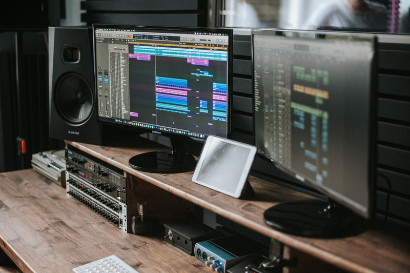 FL Studio production setup with colorful DAW playlist on studio monitor